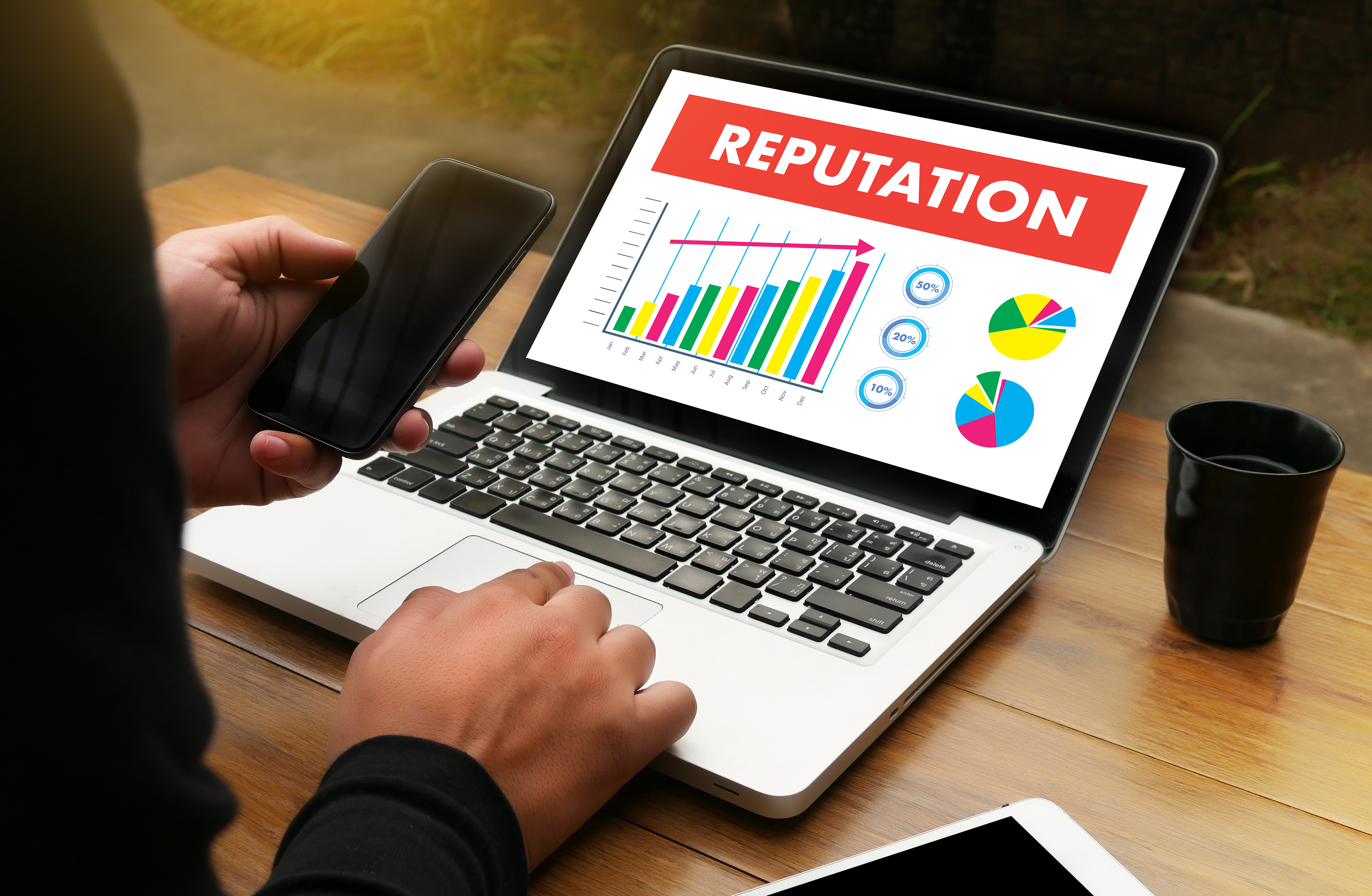 image of a laptop with graphs repsenting a brand's reputation measurement
